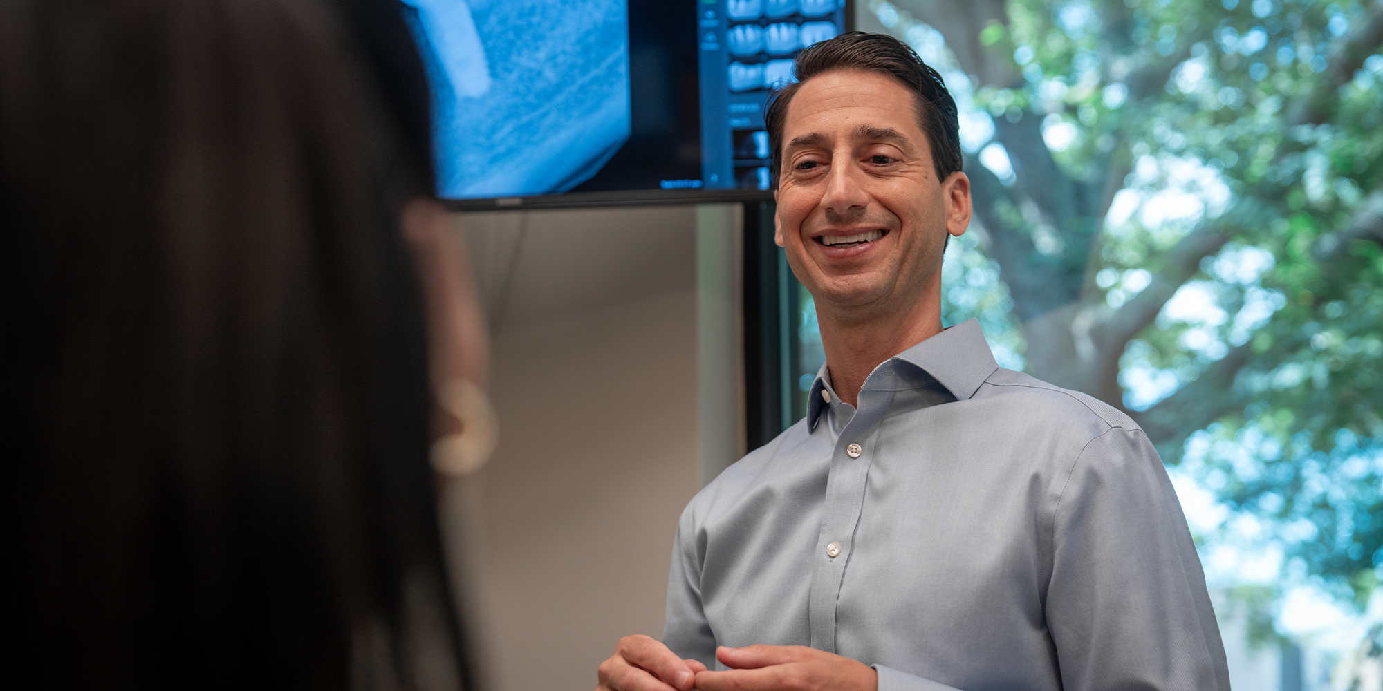 Dr. Ryan Mendro smiling at a patient in the consult room